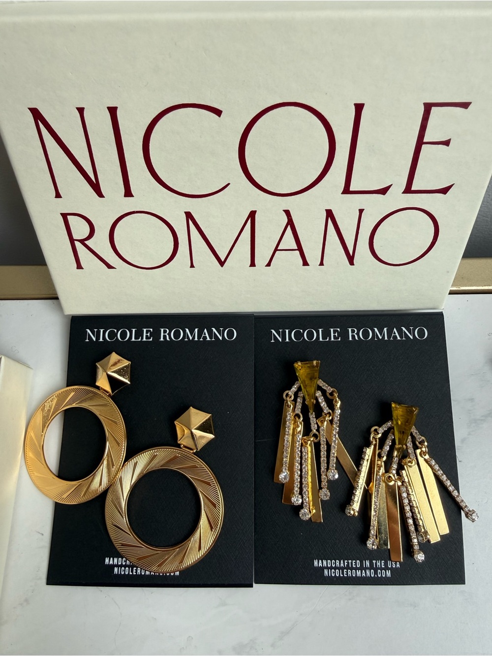 Nicole Romano, selling two pairs BNWT earrings. Ragetti Triangle, Crystal Burst